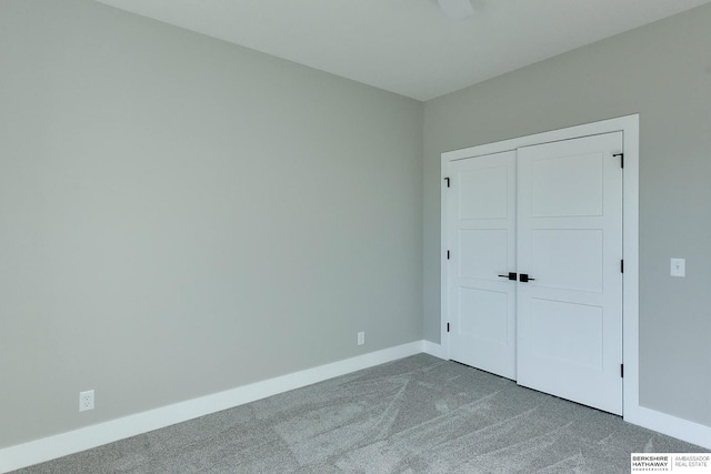 unfurnished bedroom with carpet floors and a closet