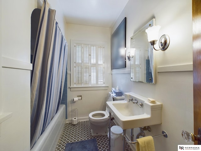 full bathroom with sink, shower / bath combo, and toilet