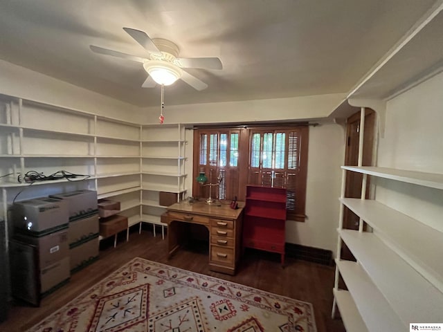 home office with ceiling fan and dark hardwood / wood-style flooring