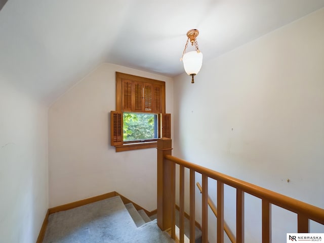 additional living space featuring lofted ceiling and carpet flooring