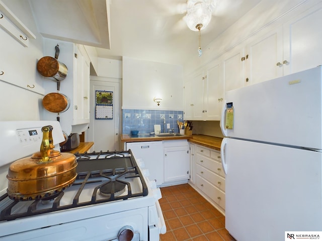 kitchen featuring butcher block countertops, sink, white cabinets, white appliances, and backsplash