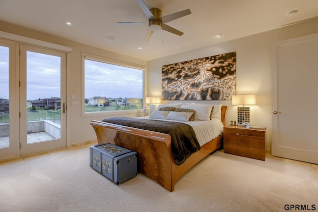 bedroom featuring multiple windows, light carpet, access to outside, and ceiling fan