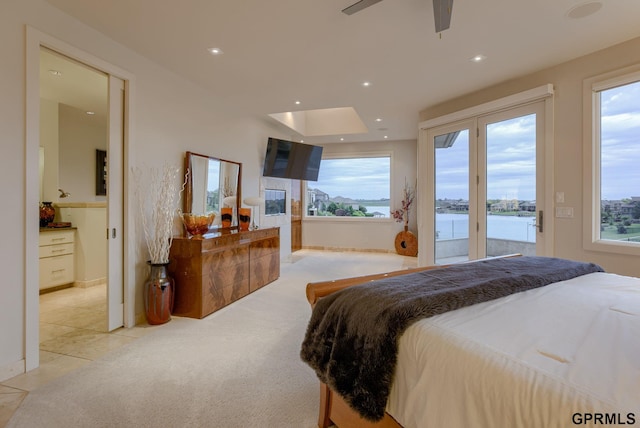 bedroom with access to outside, light colored carpet, and ceiling fan