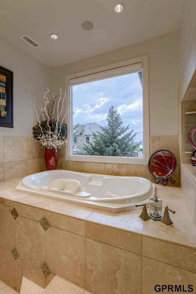 bathroom with tiled tub