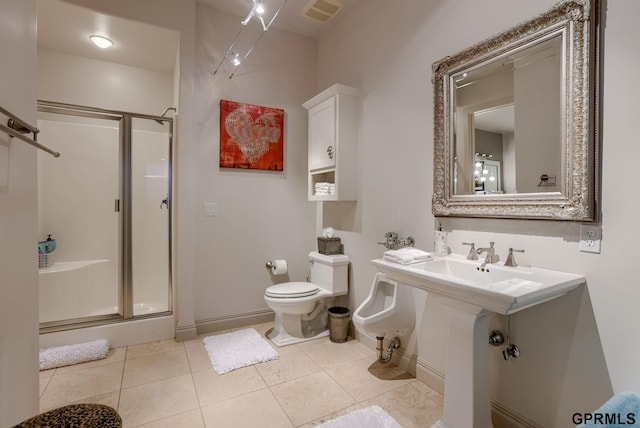 bathroom with tile patterned flooring, a shower with door, and toilet