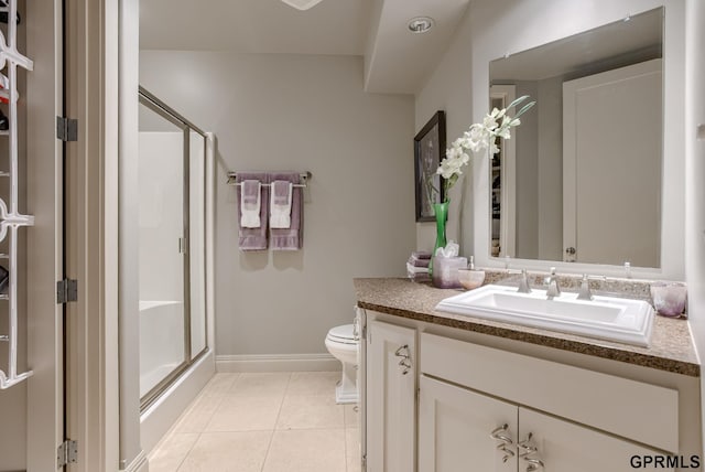 bathroom featuring vanity, tile patterned flooring, toilet, and walk in shower