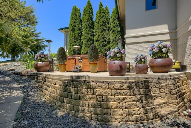 view of storm shelter with a patio