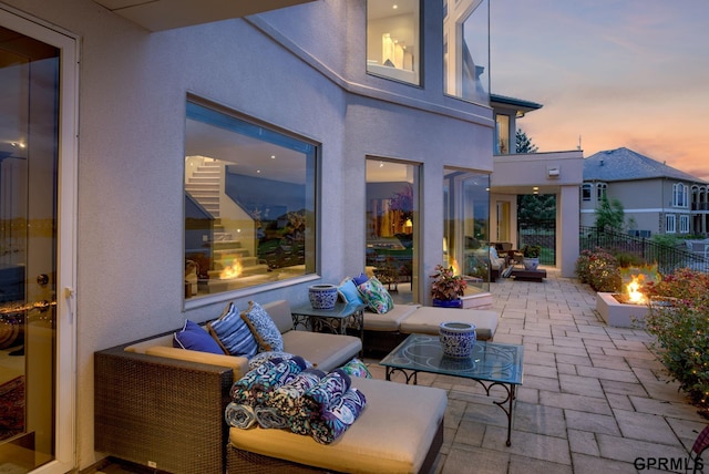 patio terrace at dusk featuring an outdoor hangout area