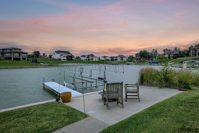 view of dock featuring a water view and a lawn