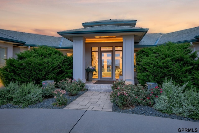 view of exterior entry at dusk