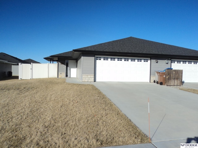 view of front of property with a garage and a front lawn