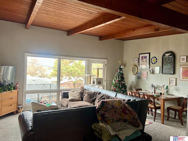 living room featuring beamed ceiling, carpet, and wood ceiling