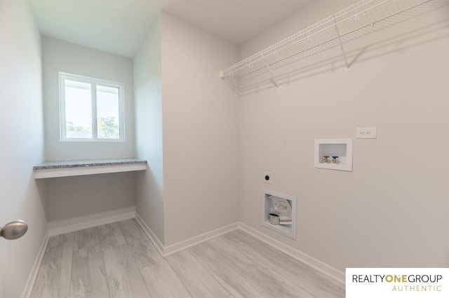 washroom featuring washer hookup, hookup for an electric dryer, and light wood-type flooring