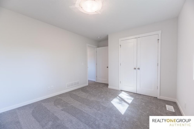 unfurnished bedroom featuring a closet and carpet