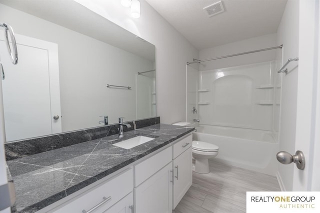 full bathroom featuring toilet, vanity, bathtub / shower combination, and hardwood / wood-style floors