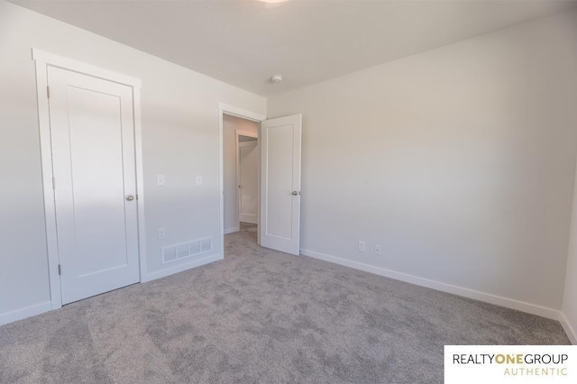 unfurnished bedroom featuring light carpet