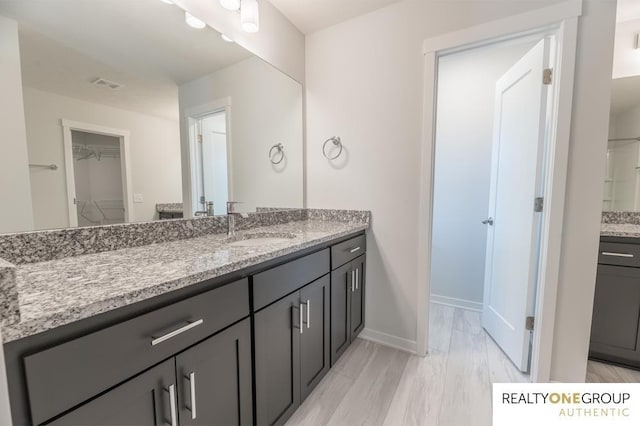 bathroom featuring vanity and hardwood / wood-style floors