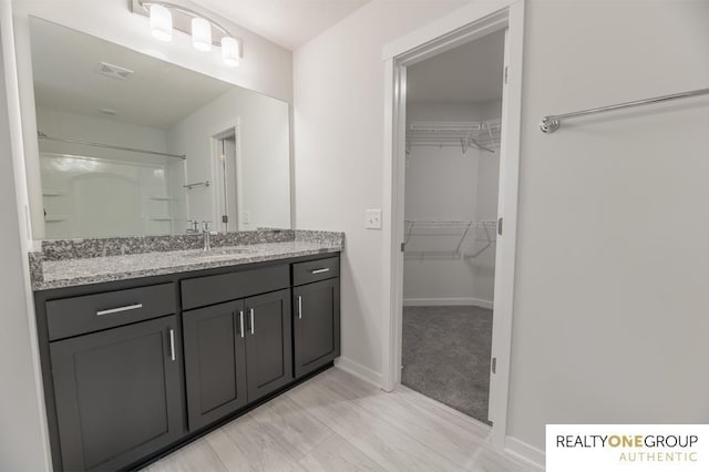 bathroom featuring vanity and a shower