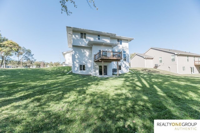 back of property with a lawn and a deck