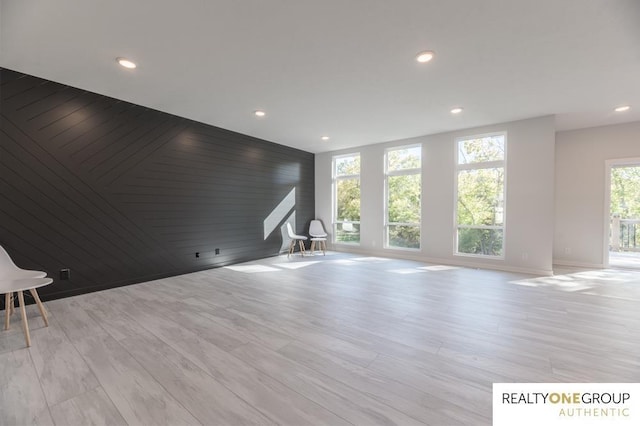 unfurnished living room featuring light hardwood / wood-style floors and a healthy amount of sunlight