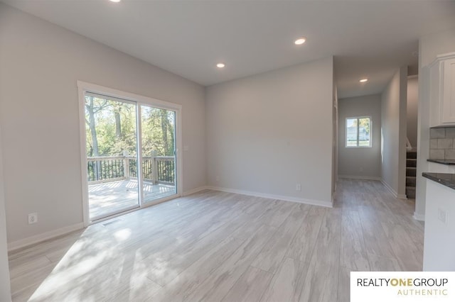 unfurnished living room featuring light wood-type flooring