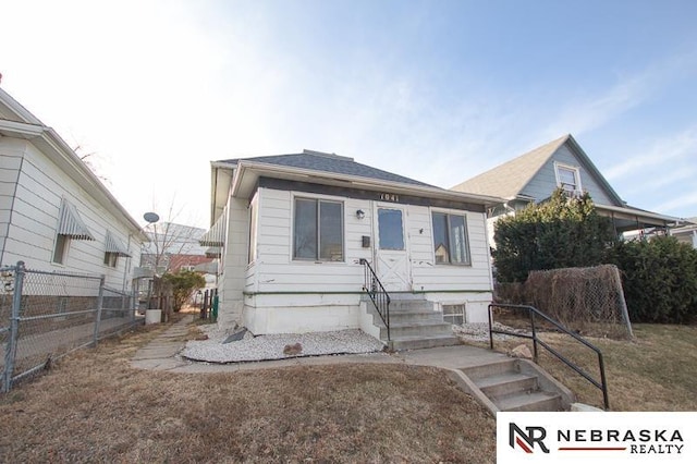 bungalow-style house with a front lawn