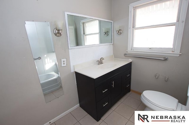 bathroom with tile patterned flooring, vanity, and toilet