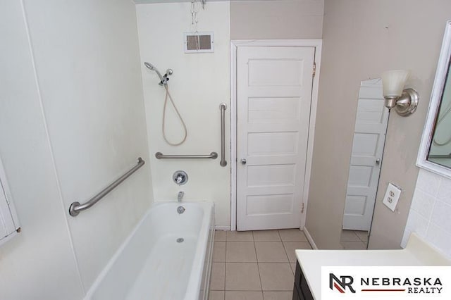 bathroom with vanity, tile patterned floors, and a tub