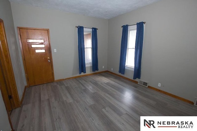 entryway with hardwood / wood-style flooring and a textured ceiling