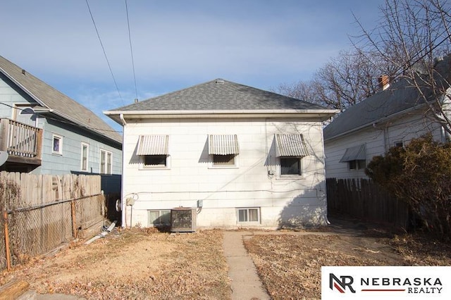 rear view of property with cooling unit