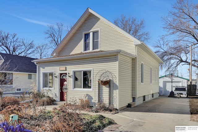 view of front of house with a garage and an outdoor structure