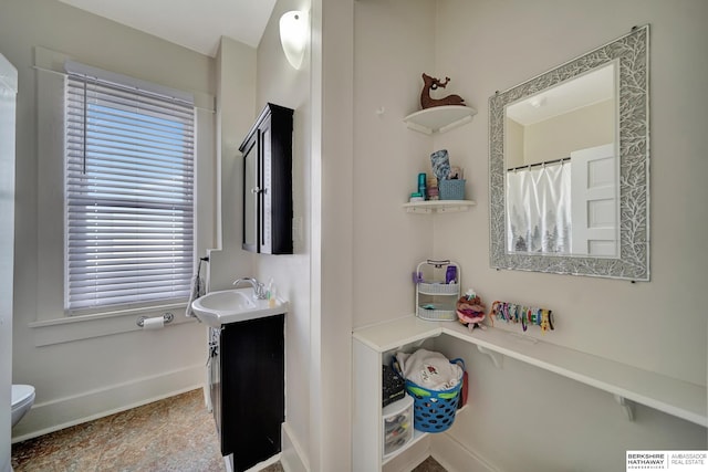 bathroom featuring vanity and toilet