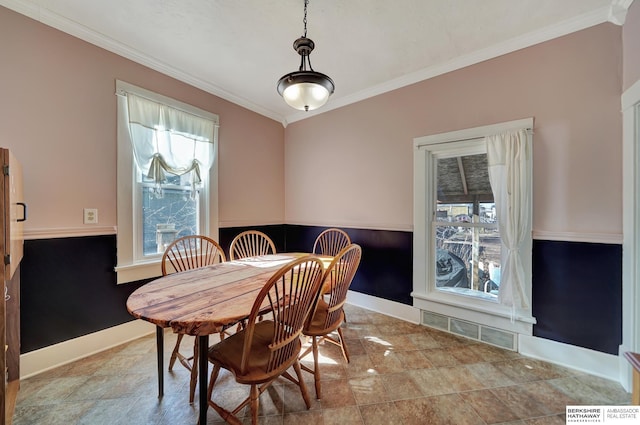 dining space with ornamental molding and a wealth of natural light