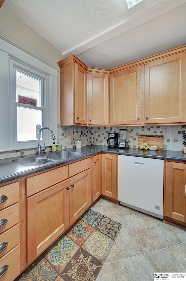 kitchen with white dishwasher, sink, tasteful backsplash, and light tile patterned flooring