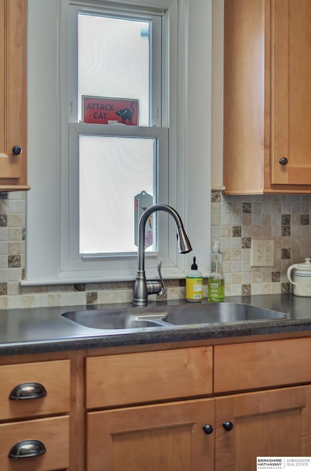 kitchen with sink, backsplash, and plenty of natural light