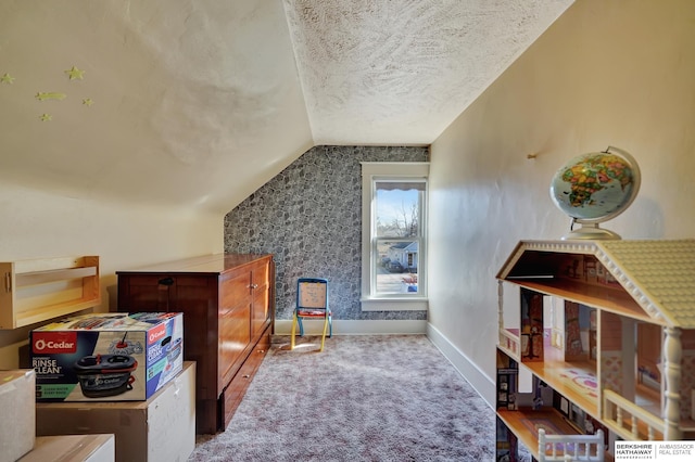 interior space with lofted ceiling, carpet flooring, and a textured ceiling