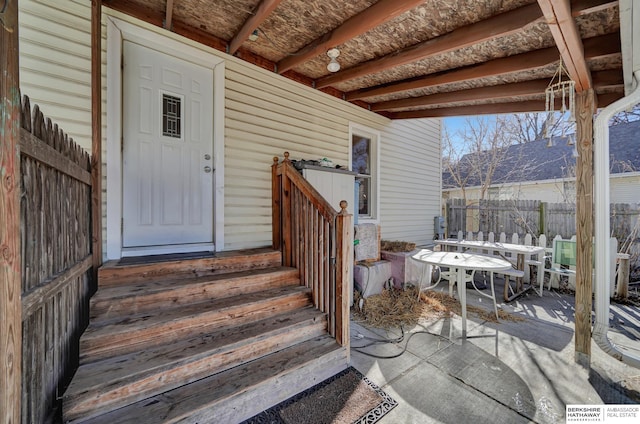 entrance to property with a patio