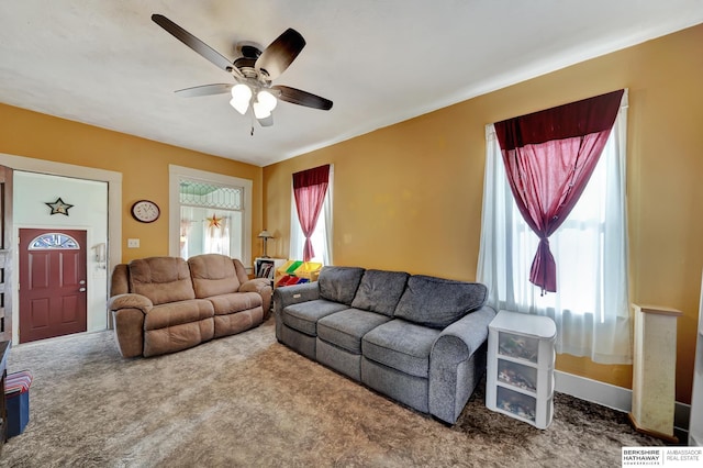 carpeted living room with ceiling fan