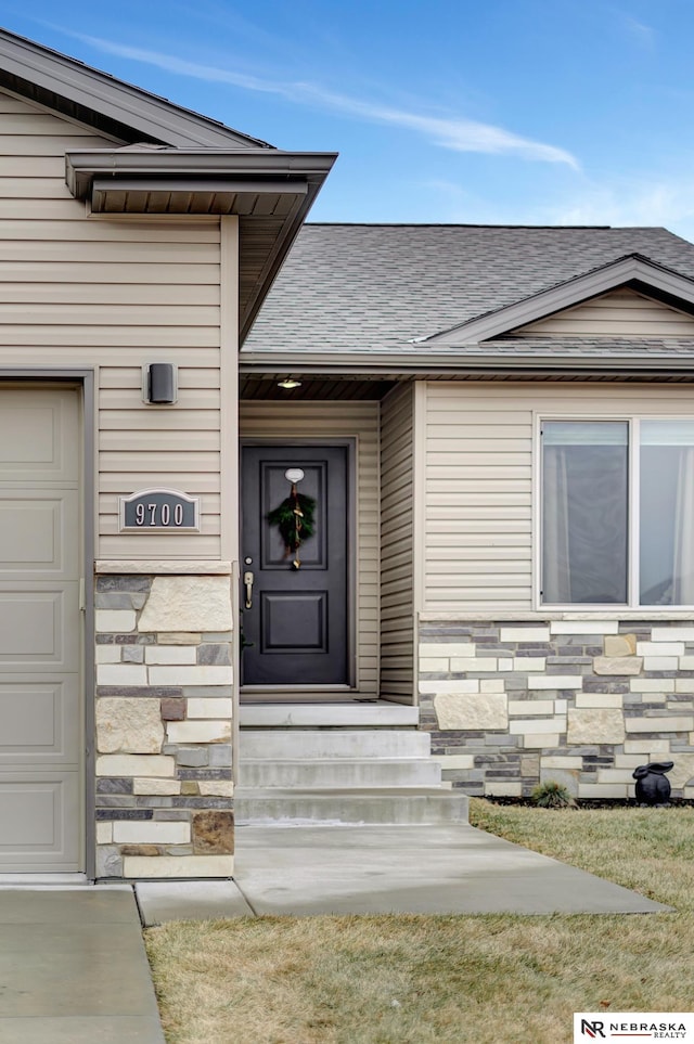 view of exterior entry featuring a garage