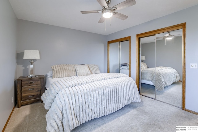 bedroom with two closets, light colored carpet, and ceiling fan