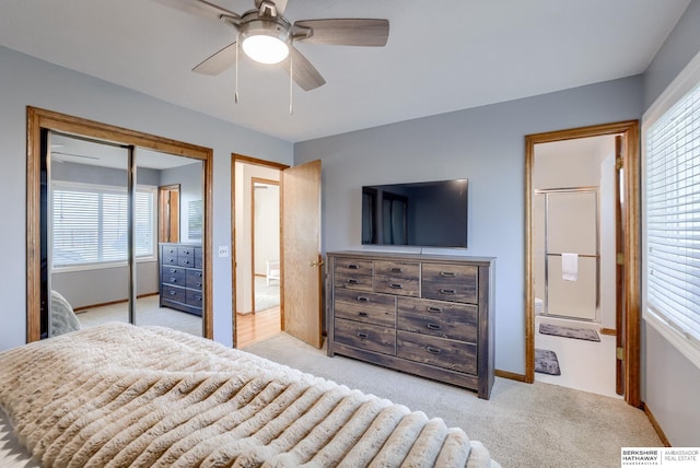 carpeted bedroom featuring ensuite bath, a closet, and ceiling fan