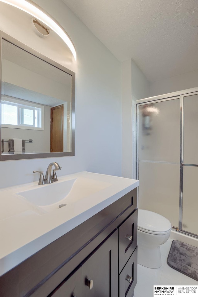 bathroom with vanity, tile patterned floors, and walk in shower