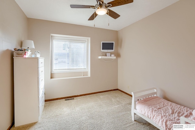 bedroom featuring ceiling fan and light carpet