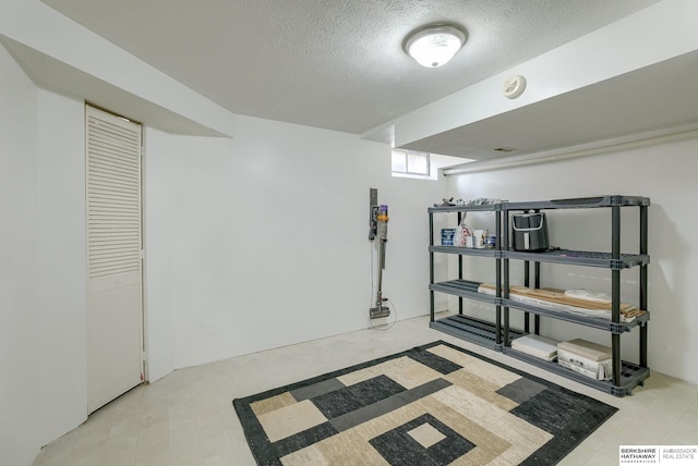 basement featuring a textured ceiling