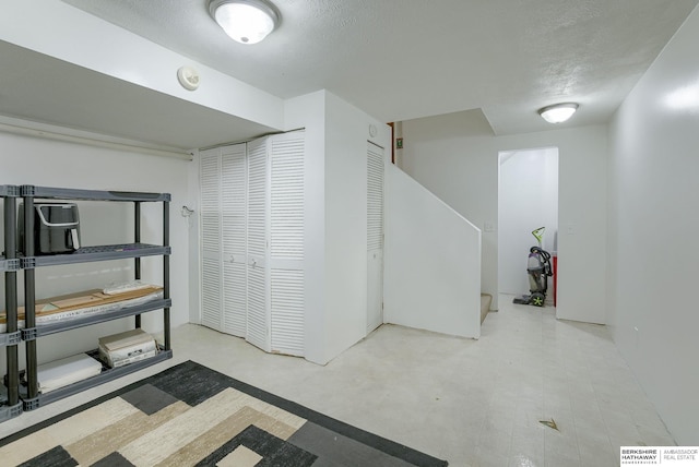 basement featuring a textured ceiling