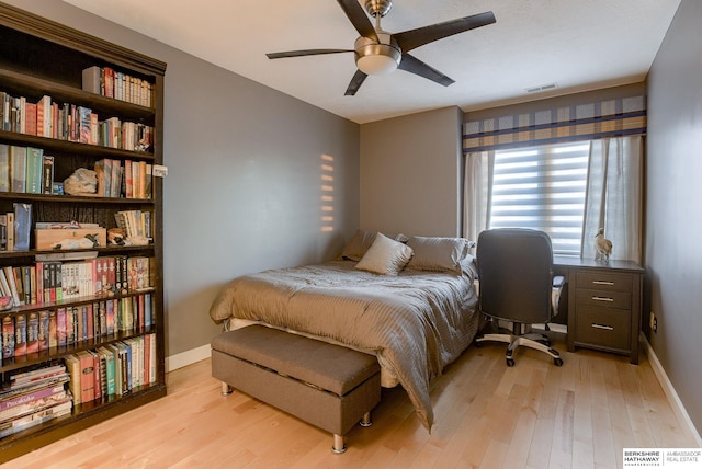 bedroom with ceiling fan and light hardwood / wood-style flooring