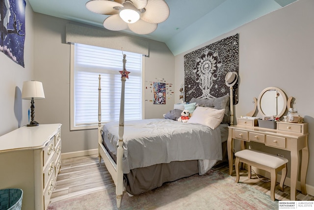 bedroom with lofted ceiling, ceiling fan, and light hardwood / wood-style flooring