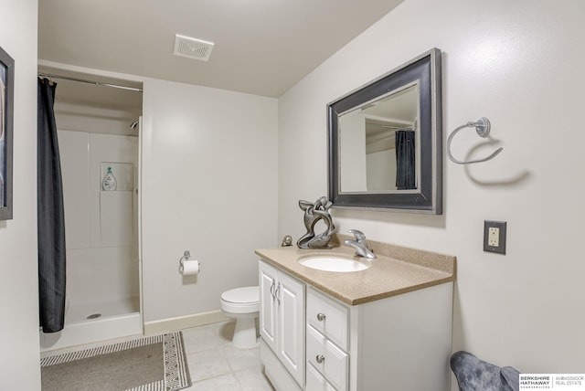 bathroom with tile patterned flooring, vanity, a shower with curtain, and toilet