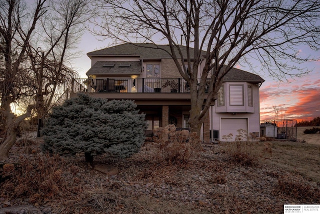 view of front facade with a garage and a wooden deck