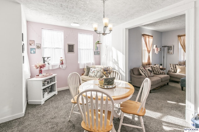 dining area with an inviting chandelier, carpet floors, and a textured ceiling